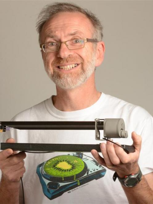 Dunedin designer and music enthusiast Simon Brown with the unipivot tonearm he has developed....