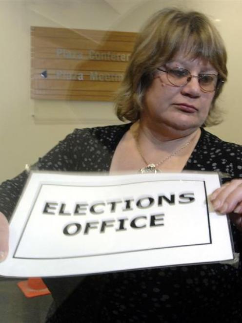 Dunedin electoral officer Pam Jordan checks the time, and closes the door of the elections office...