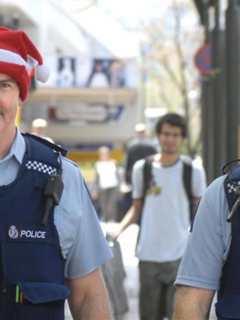 Dunedin emergency response commander Inspector Alastair Dickie (left) walks the beat through the...