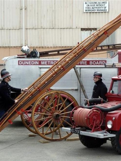 Dunedin Fire Brigade Restoration Society president Paul Clements (left) takes a close look at a...