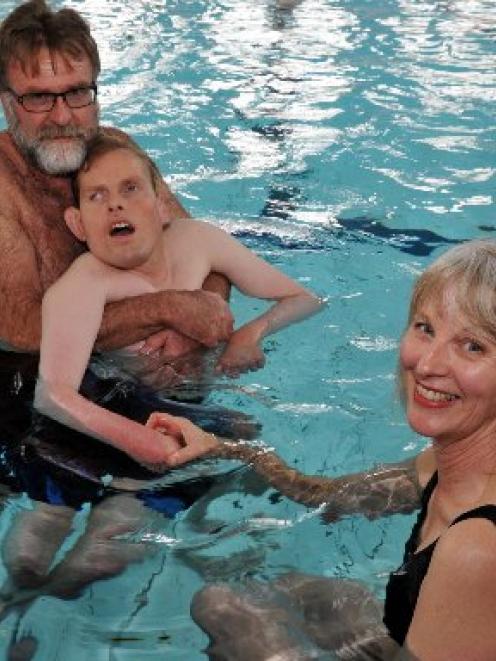 Dunedin man Chris Rollo, who has cerebral palsy, spends time in the pool with his parents Graham...