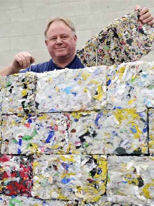 Dunedin man Peter Lewis shows off the bricks of recycled plastic made at the Green Island...