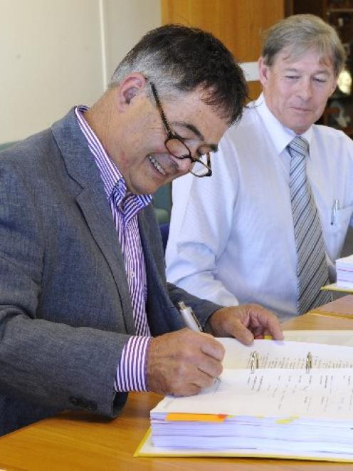 Dunedin Mayor Dave Cull signs the $26.7 million contract for Dunedin's new kerbside collection...