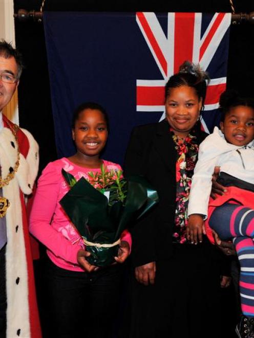 Dunedin Mayor Dave Cull with  new New Zealand citizens (from left) Ruvarashe Manonose (11), her...