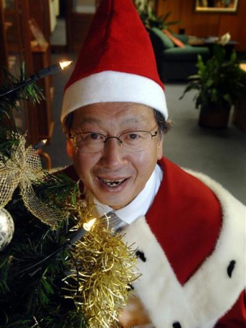 Dunedin Mayor Peter Chin gets into the Christmas spirit in his chambers yesterday, in preparation...