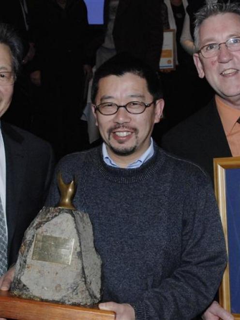 Dunedin Mayor Peter Chin (left) presents Dunedin Chinese Gardens Trust secretary-treasurer...