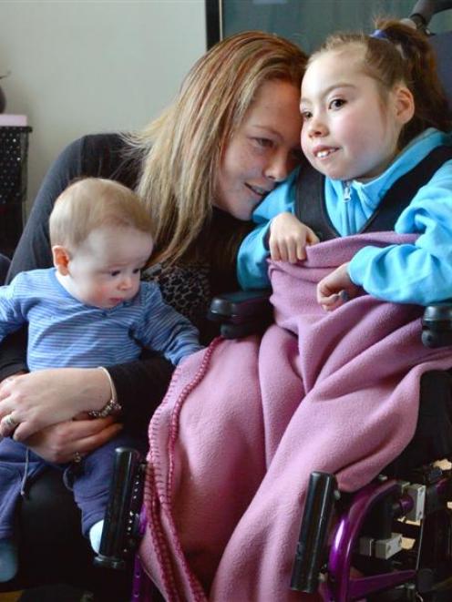 Dunedin mother Kelly Gibbs, holding her 5-month-old son William, is fundraising for a mobility...