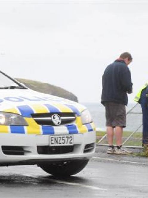 Dunedin police and Delta Utility Services staff on John Wilson Ocean Dr yesterday, where the...