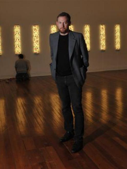 Dunedin Public Art Gallery curator Aaron Kreisler stands amid  the 'Te Po' exhibition while ...
