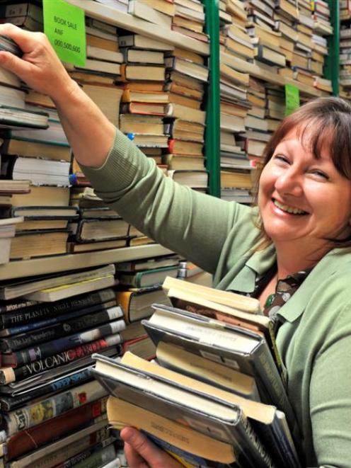 Dunedin Public Libraries marketing co-ordinator Kay Mercer holds stock set for the library's...