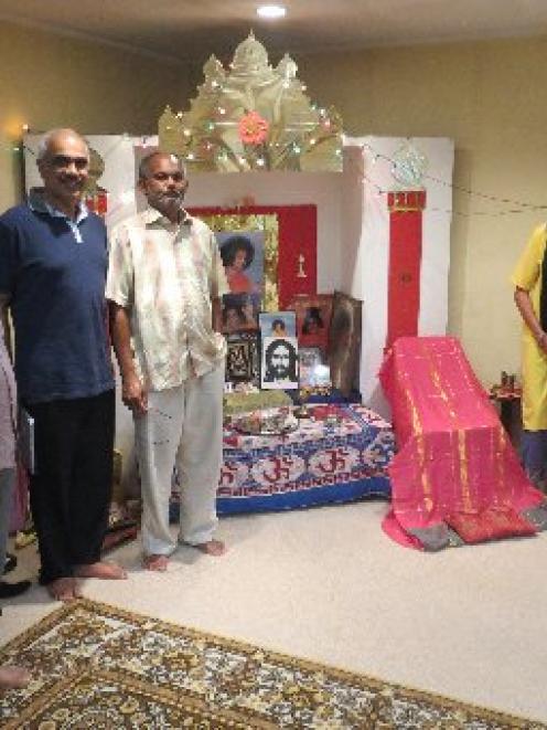 Dunedin's Sathya Sai Baba Hindu group members worship at household altars like this one as they...