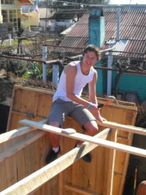 Dunedin student Billy Greer works on a house frame in Chile as part of a rebuilding effort after...