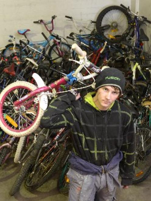 Dunedin Training Centre trainee Zane Grant (17) moves the consignment of Christchurch bikes...