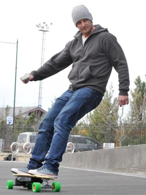 Eamon Maze rides his electric longboard in Dunedin. Photo by Craig Baxter.