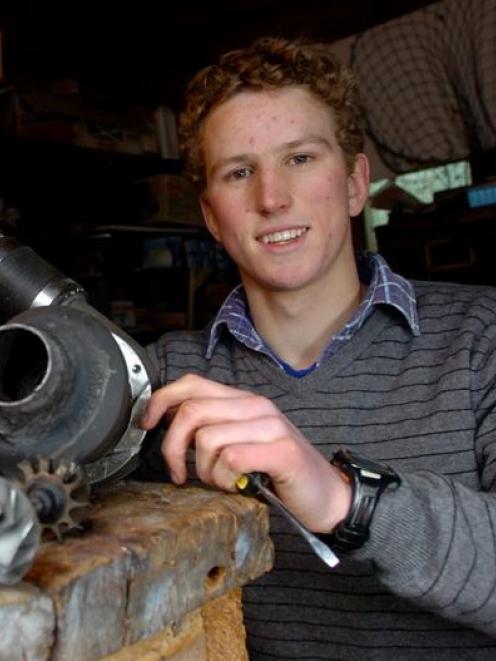 East Otago High School pupil Lachlan Matchett with a jet engine he built in his parents' garden...