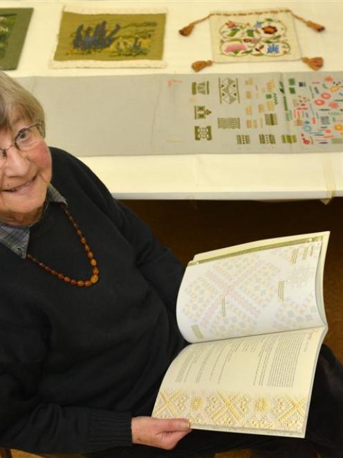 Embroiderer Gay Eaton with her book,  Ukrainian Whitework,  and an array of embroidery items she...