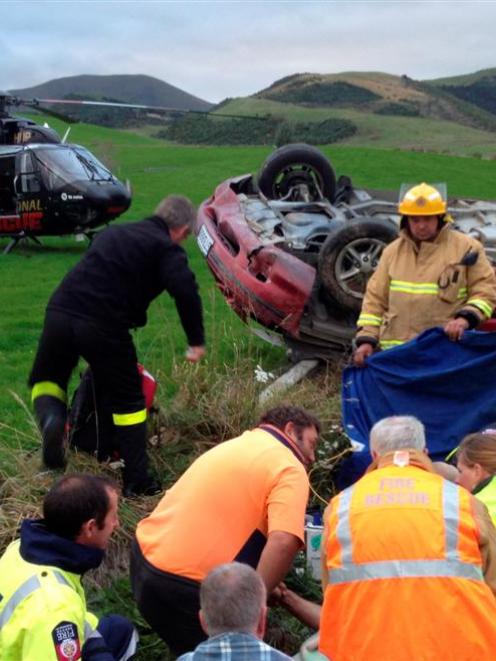 Emergency services attend a car crash near Raes Junction yesterday. Photo by Otago Regional...