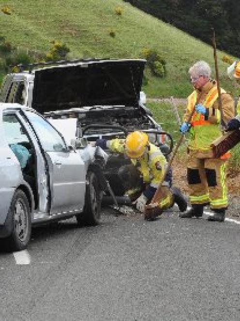 Emergency services clean up the scene of a serious accident on Highcliff Rd on Saturday after a...