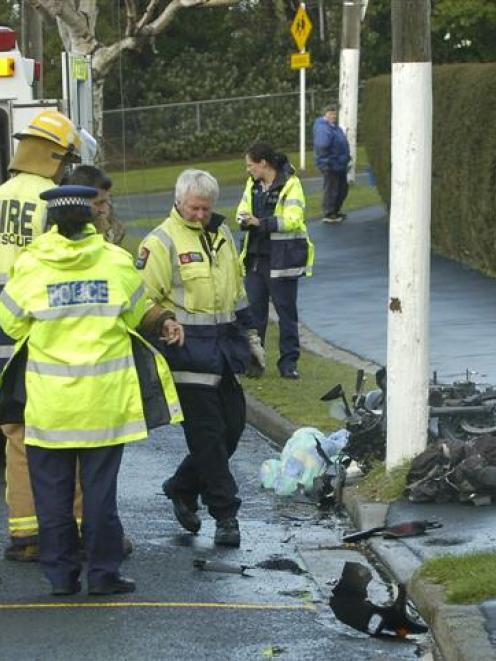 Emergency services staff work at the scene of a motorcycle crash in Pine Hill, Dunedin, last...