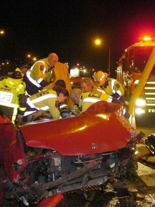 Emergency services staff work to free a 14-year-old girl from a car following a high-speed crash...
