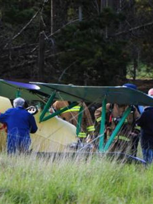 Emergency services surround a plane which suffered a power failure near Waldronville last night....