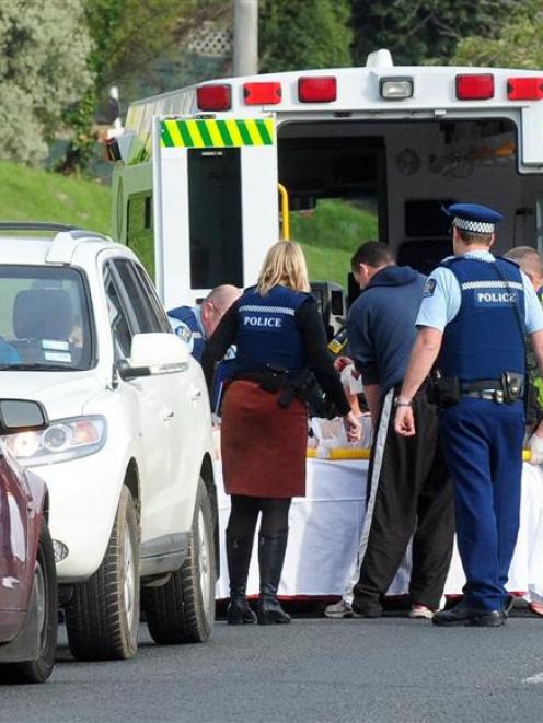 Emergency services treat a woman after a violent domestic incident in South Rd, Dunedin, last...