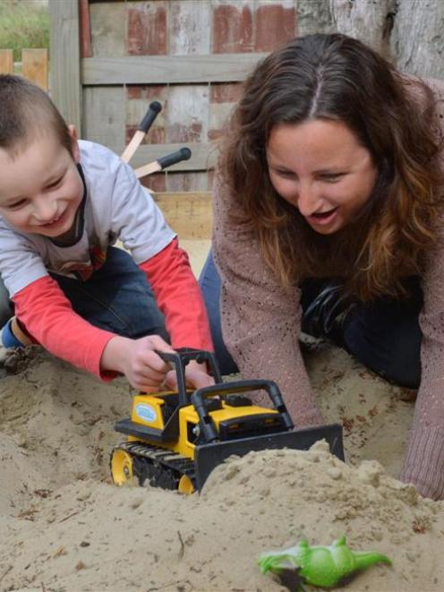 Emma Currie enjoys some time in the sandpit with son Eli (4).  Photo by Gerard O'Brien.