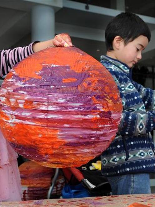 Emma Small (4) and  brother Sean (6) transform paper lamp shades into Venus-like orange planetary...