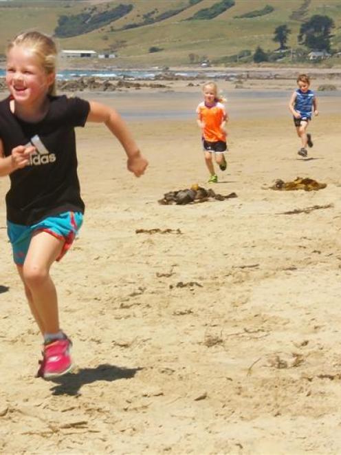 Emmy Marshall (5) is followed by her twin sister Lulu and cousin Benji May (5)  during  the...