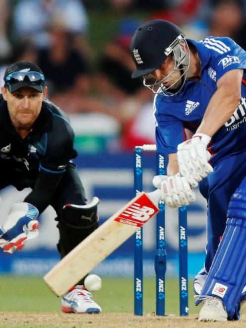 England batsman Jonathan Trott plays a shot watched by New Zealand wicketkeeper Brendon McCullum...