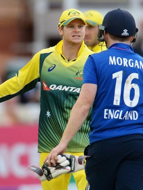 England captain Eoin Morgan (16) has words with his Australia counterpart Steve Smith. Action...