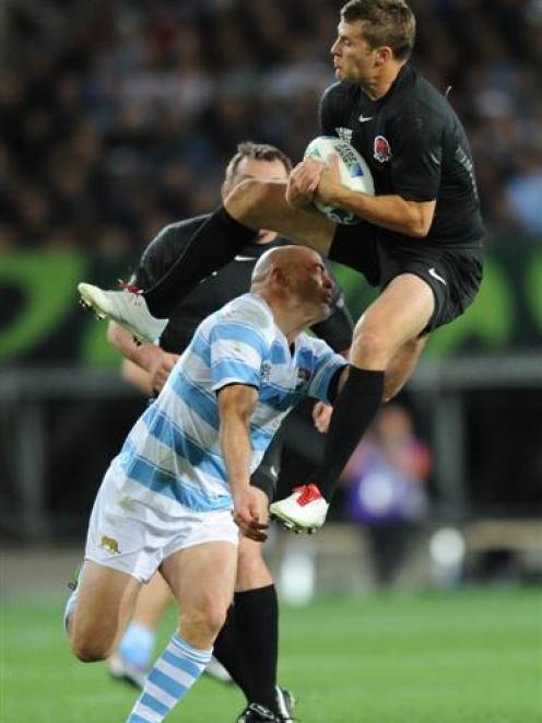 England halfback Richard Wigglesworth takes a high ball as Argentina captain and first five...