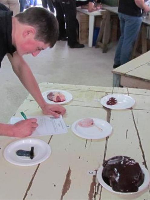 England representative Alastair Graham (21) attempts to classify sheep organs at the World Youth...