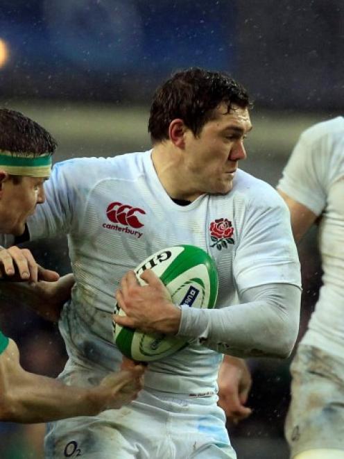 England's Alex Goode (C) holds off Ireland's Brian O'Driscoll during their Six Nations match at...