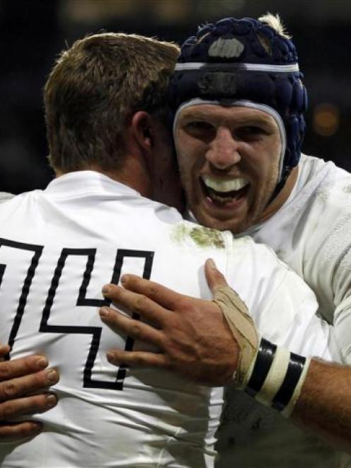 England's Chris Ashton celebrates with teammate James Haskell after scoring a try against Romania...