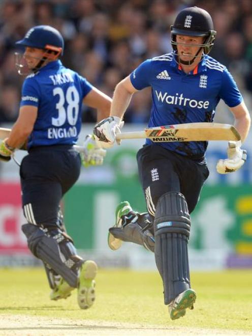 England's Eoin Morgan and James Taylor run between the wickets. Photo: Reuters.
