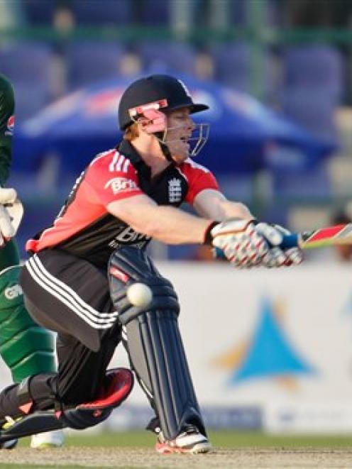 England's Eoin Morgan, right, is dismissed lbw during the one-day match against Pakistan at the...