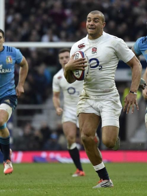 England's Jonathan Joseph (2nd right) breaks through the Italian ranks to score his second try...