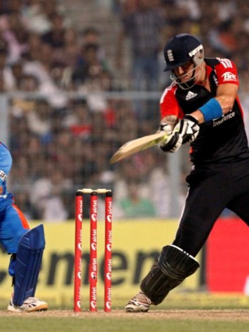 England's Kevin Pietersen plays a shot as India captain MS Dhoni watches during their Twenty20...