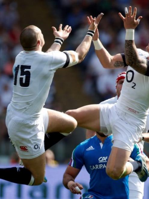 England's Mike Brown (L) and Jack Nowell jump to take a high ball. REUTERS/alessandro Bianchi