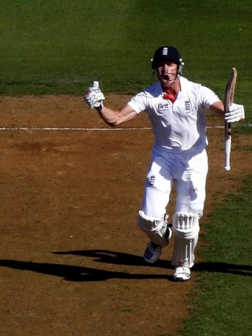 England's Nick Compton celebrates reaching his century as New Zealand's Neil Wagner reacts during...
