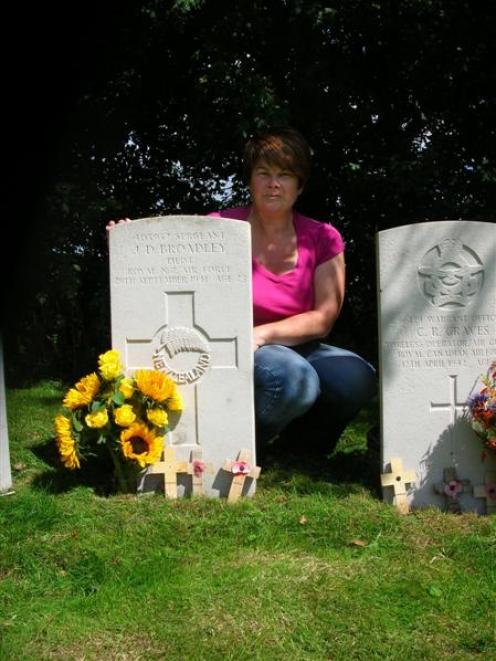 Englishwoman Sally Higgins, who tends the war grave of New Zealand pilot Sergeant Jack Broadley,...