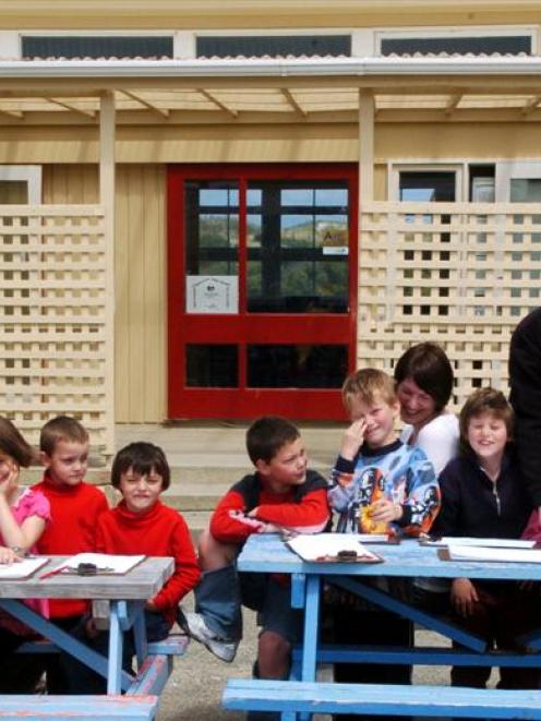 Enjoying an outdoor lesson at Tomahawk School yesterday are pupils (from left) Toni Fowler (9),...