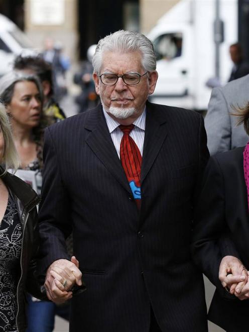 Entertainer Rolf Harris arrives with his daughter Bindi (left) and niece Jenny at Southwark Crown...