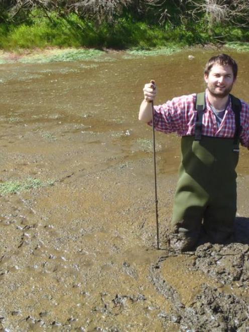 Environment Southland aquatic ecologist Dr Andy Hicks takes samples from a silt pond on a...