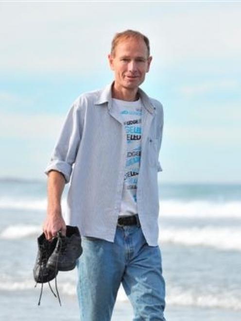 Euthanasia advocate Prof Sean Davison walks in the water at St Clair Beach yesterday on his first...