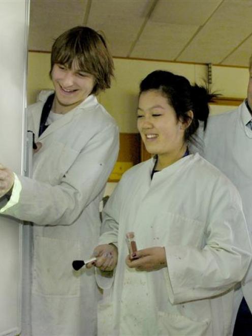 Examining the image of a fingerprint projected on a wall yesterday are (from left) Joel Labes (16...