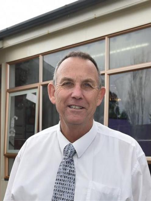 Fairfield School principal Andy Larson outside one of the school's four prefabricated classrooms...