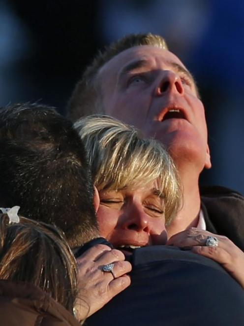 Families grieve outside Sandy Hook Elementary School. Photo by Reuters