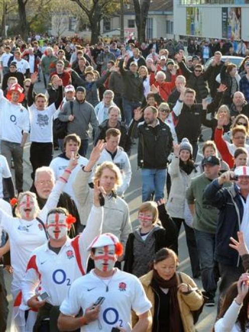 Fans pour towards Otago Stadium ahead of the Rugby World Cup clash between England and Georgia in...